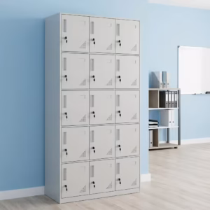 Premium 15 Locker Office Steel Cabinet in a professional light grey powder-coated steel finish, showcasing a 3x5 grid layout of fifteen closed locker doors with recessed handles, cylinder locks with keys inserted, name card frames, and stamped bottom ventilation patterns, standing flat on smooth light wood flooring against a textured grey wall.