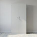2-Door Office Cabinet (metallic) featuring a tall rectangular shape, light grey metallic doors, two vertical recessed handles, a central key lock with keys, and a solid base plinth.