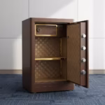 60 Kgs fireproof home/office safe featuring a brown textured finish, gold-toned base trim, electronic keypad with fingerprint scanner, circular gold handle, four polished cylindrical locking bolts, diamond-patterned fabric interior lining, and an internal wood-grain finish lockable drawer.