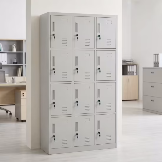 Premium 15 Locker Office Steel Cabinet in a professional light grey powder-coated steel finish, showcasing a 3x5 grid layout of fifteen closed locker doors with recessed handles, cylinder locks with keys inserted, name card frames, and stamped bottom ventilation patterns, standing flat on smooth light wood flooring against a textured grey wall.