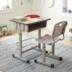 An adjustable Modern Kid’s Desk & Chair set featuring a light wood-grain desktop, an integrated grey storage cubby, a matching ventilated resin chair, a lower metal mesh basket, and a height-adjustable steel frame.