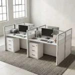 Premium modern white 4-Way Office Workstation cluster featuring four individual desks with translucent slatted privacy dividers, dual wire grommets, desktop computer setups, and integrated three-drawer lockable under-desk pedestals.