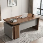 Premium 1.4M Executive Office Desk featuring a warm walnut wood grain desktop with rounded edges, a modern matte grey modesty panel, and an integrated side pedestal storage cabinet with a lockable drawer.
