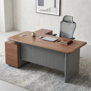 Premium L-shaped Modern Executive Office Table featuring a natural walnut grain desktop with rounded edges, a grey fluted vertical modesty panel, and a matching integrated side-return credenza cabinet.