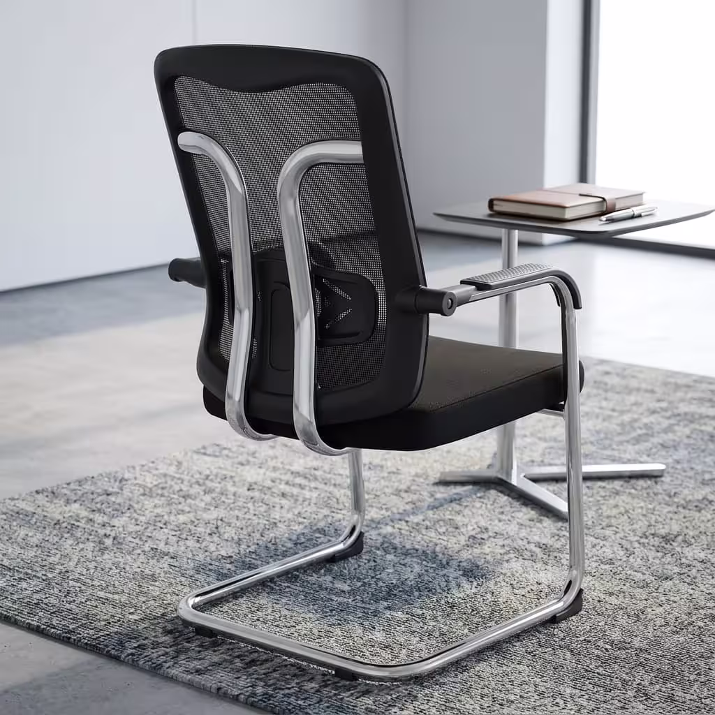Modern black Ergonomic Mesh Guest Office Seat by TBL Furniture, featuring a breathable mesh backrest, integrated armrests, and a black steel sled base, isolated against a studio backdrop.