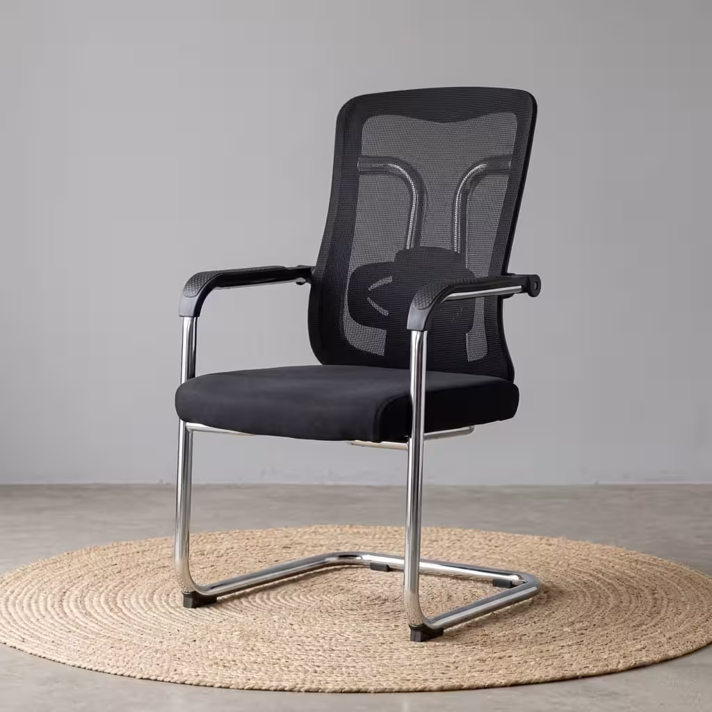 Modern black Ergonomic Mesh Guest Office Seat by TBL Furniture, featuring a breathable mesh backrest, integrated armrests, and a black steel sled base, isolated against a studio backdrop.