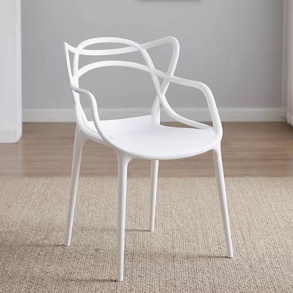 White Bistro Plastic Chair with an intricate, sweeping cut-out backrest and integrated arms, placed on a modern concrete backyard patio.