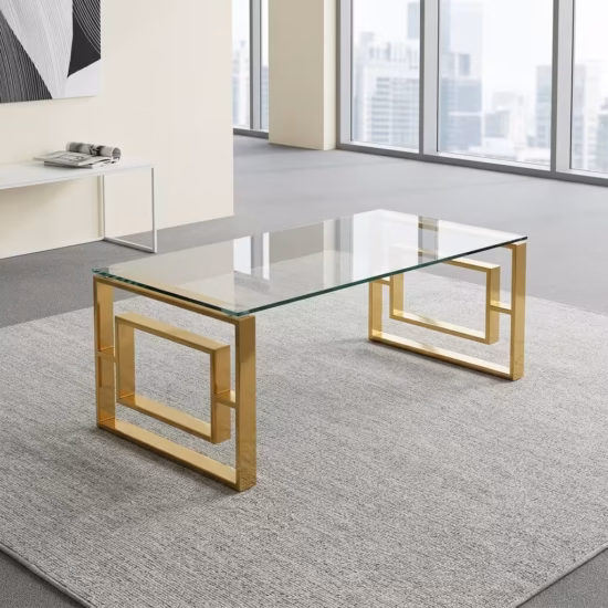 Modern Romimex Glass Coffee Table With Goldish Frame featuring a rectangular multi-coloured glass top and a geometric gold-toned metal base on a plush cream area rug.