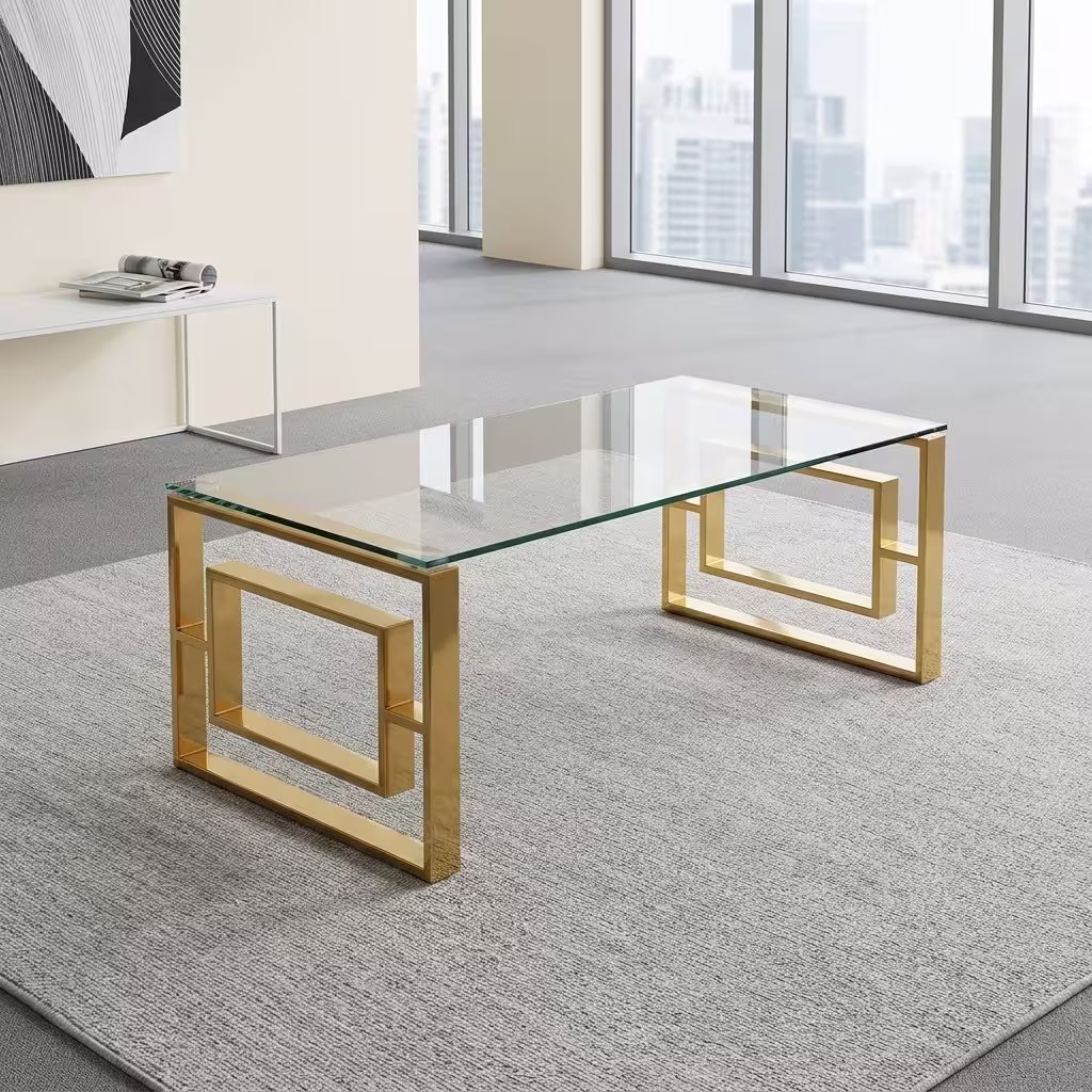 Modern Romimex Glass Coffee Table With Goldish Frame featuring a rectangular multi-coloured glass top and a geometric gold-toned metal base on a plush cream area rug.
