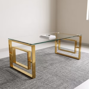 Modern Romimex Glass Coffee Table With Goldish Frame featuring a rectangular multi-coloured glass top and a geometric gold-toned metal base on a plush cream area rug.