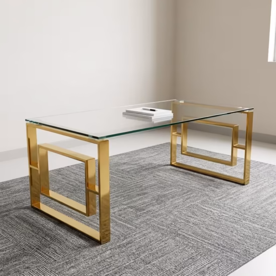 Modern Romimex Glass Coffee Table With Goldish Frame featuring a rectangular multi-coloured glass top and a geometric gold-toned metal base on a plush cream area rug.