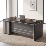 Modern 1400MM Executive Office Desk with charcoal panels, a matching rolling 3-drawer cabinet, and a desktop computer, positioned in a bright loft office.