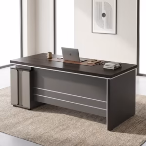 Modern 1400MM Executive Office Desk with charcoal panels, a matching rolling 3-drawer cabinet, and a desktop computer, positioned in a bright loft office.