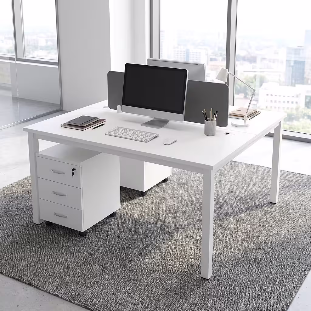 Modern White Office Workstation configured for two users face-to-face, featuring an integrated gray acoustic divider screen, laptops, and rolling 3-drawer storage units on a tan rug.