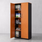 Premium 2-Door Wooden Lockable Office Storage Cabinet in a rich cherry wood and matte black finish, showcasing two open vertical swing doors with a centered silver key lock cylinder and vertical metal handles, displaying organized binders, notebooks, and folders on five internal shelves, standing on a polished concrete floor.