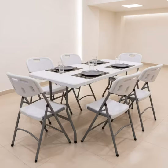 Premium Foldable Table & Chair Dining Set featuring a rectangular white plastic folding tabletop, supported by a heavy-duty powder-coated gray steel frame, surrounded by six matching white plastic folding chairs with integrated carrying handles on a light wood floor.
