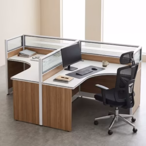 Premium 2-Way Curved Office Workstation showcasing an elevated perspective of a back-to-back dual user layout, featuring curved L-shaped white tables with natural woodgrain side panels, integrated translucent slatted glass privacy partition screens, and active workspaces with a curved monitor, laptop, and a black mesh ergonomic task chair on a smooth grey concrete floor.