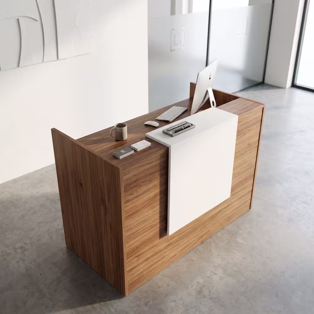 Premium 1.2M Wooden Reception Counter Office Desk featuring a rich walnut woodgrain panel facade, a center-set cascading waterfall-edge white transaction counter supporting a silver laptop, a pen holder set, and stacked books, resting on a polished grey concrete floor.