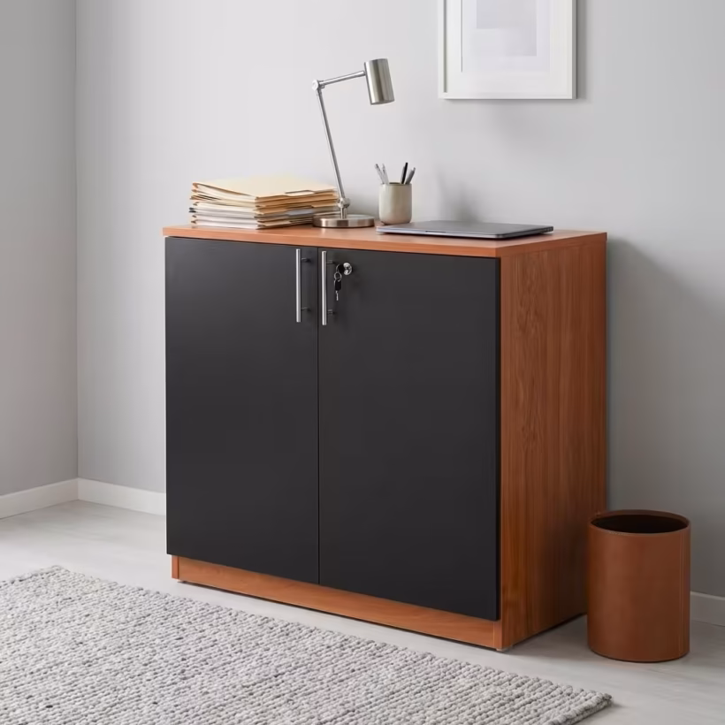 Premium 2-Door Wooden Storage Office Cabinet in a rich walnut woodgrain finish, showcasing two closed vertical swing doors with a centered silver key lock cylinder, standing on a polished concrete floor in a modern corporate office layout.
