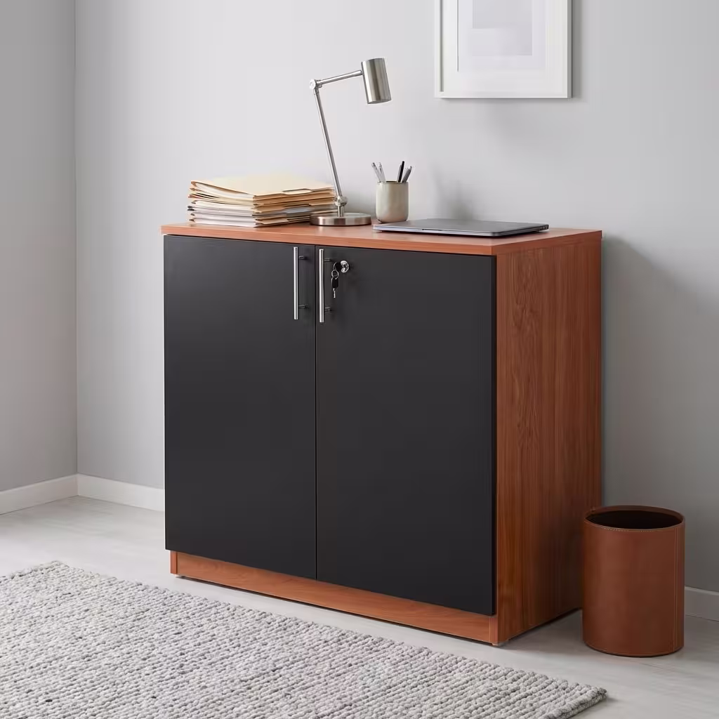 Premium 2-Door Wooden Storage Office Cabinet in a rich walnut woodgrain finish, showcasing two closed vertical swing doors with a centered silver key lock cylinder, standing on a polished concrete floor in a modern corporate office layout.