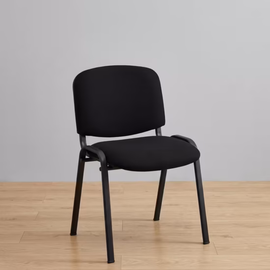 Premium Tosca Stackable Visitor Chair featuring rounded black fabric cushions, an armless low-back profile, and a sturdy four-legged matte black steel frame, standing on a light wood floor against a grey wall.