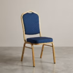Premium Blue Banquet Chair With Gold Steel Frame featuring a crown-back design in royal blue fabric with gold dots and a highly reflective glossy gold steel frame, standing on a polished event floor.