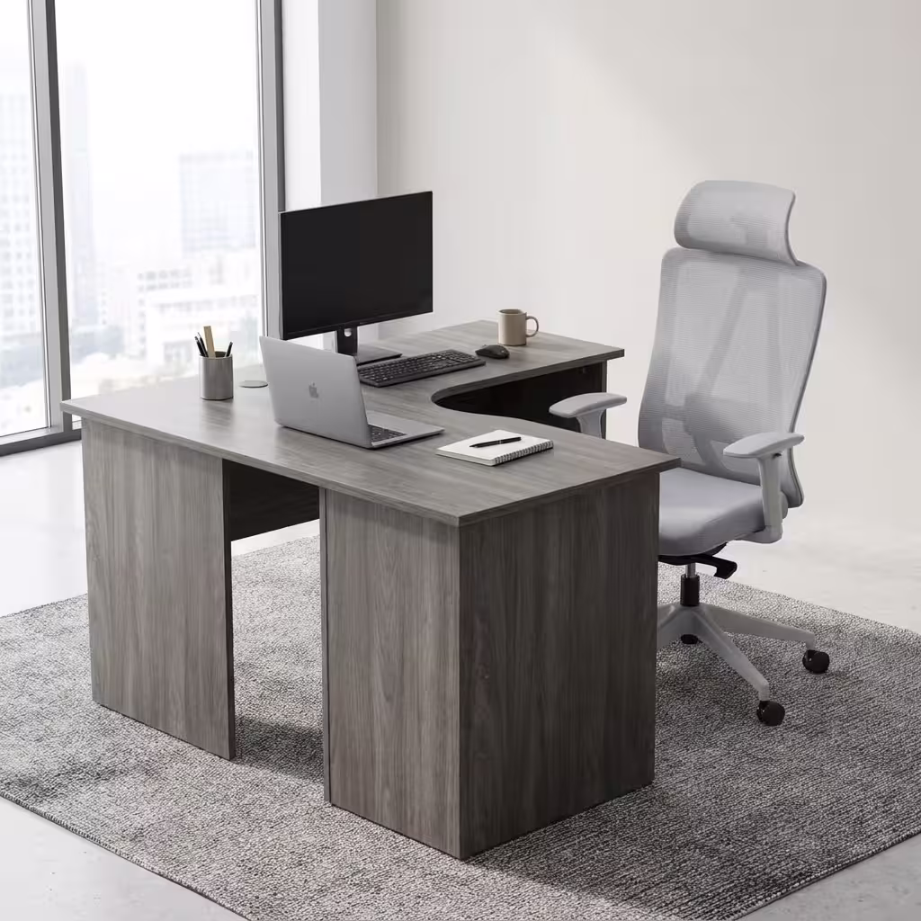 Premium 1.4M Curved Office Desk in a modern oak wood finish with black metal legs, displaying a laptop and office documents in a bright workspace corner.