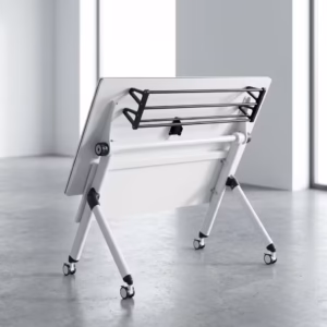 Premium 1.2M Foldable Training Office Table with a smooth white top, front black privacy baffle, and a white metal frame on lockable caster wheels, shown in a modern classroom.