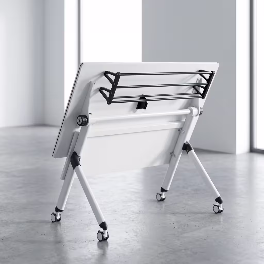 Premium 1.2M Foldable Training Office Table with a smooth white top, front black privacy baffle, and a white metal frame on lockable caster wheels, shown in a modern classroom.