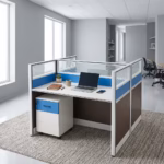 Premium 2-Way Workstation With Mobile Pedestal in a white and dark grey finish, displaying a back-to-back cubicle layout with a sleek laptop, writing utensils, a ceramic mug, electric blue accents, and an integrated lockable under-desk mobile filing cabinet resting on a light grey carpet.