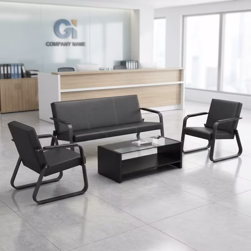 Premium 5-Seater Reception Office Sofa Set in smooth matte black faux leather, featuring thick tufted cushions, structural padded armrests with vertical silver accent trim lines, placed in a modern corporate lobby.
