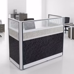 Premium One-Way Modular Office Workstation in a rich walnut woodgrain finish, showcasing a single rectangular tabletop with an integrated privacy partition panel, a lockable storage drawer unit with a key inserted, displaying a silver laptop and a ceramic mug, standing on a polished concrete floor.