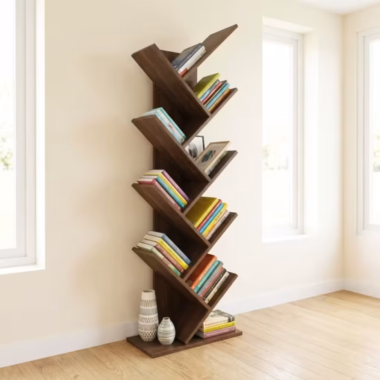 Premium Wooden Standing Bookshelf featuring an artistic tree-shaped geometric layout with 9 tiers of angled walnut branches holding colorful books, resting on light oak flooring in a bright modern office corner.