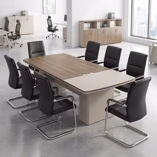Premium 6-8 Seater Modern Executive Boardroom Table featuring a dual-tone walnut and cream tabletop with integrated cable routing ports, surrounded by black leather cantilever chairs inside a bright contemporary office suite.