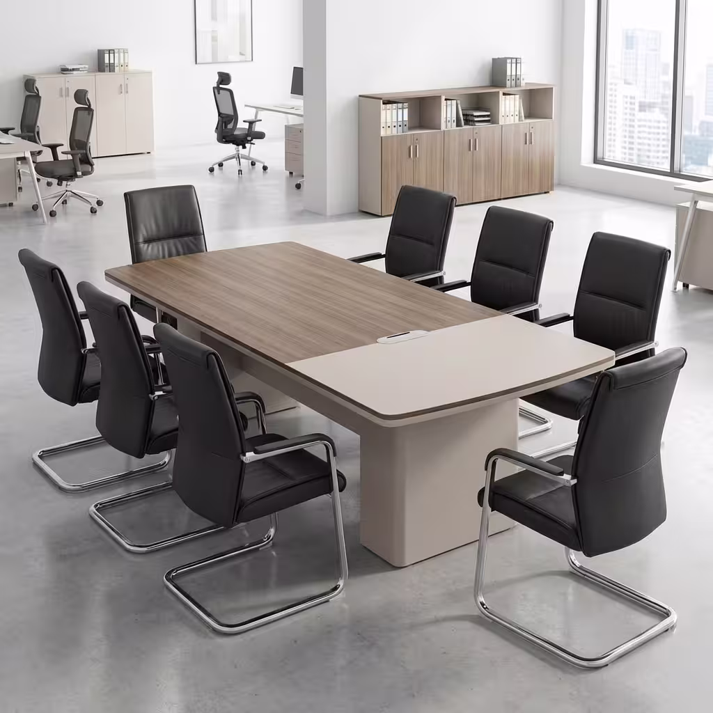 Premium 6-8 Seater Modern Executive Boardroom Table featuring a dual-tone walnut and cream tabletop with integrated cable routing ports, surrounded by black leather cantilever chairs inside a bright contemporary office suite.