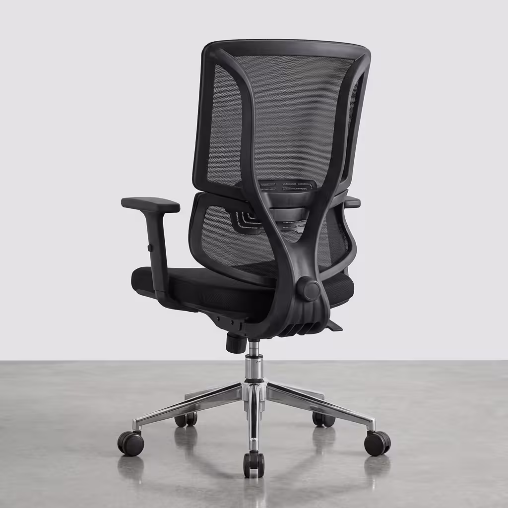 Premium mid-back Office Chair With Lumbar Support featuring a black open-mesh backrest, adjustable T-shaped armrests, a thick fabric seat cushion, and a reflective polished chrome star base with rolling wheels, standing on a polished concrete floor.