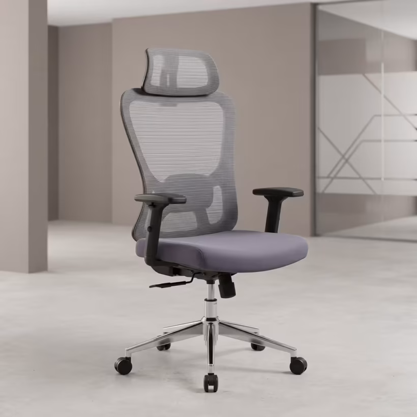 Premium High-Back Grey Mesh Ergonomic Office Chair featuring an open-airflow grey mesh backrest, matching adjustable headrest, flat black T-shaped armrests, a plush grey seat cushion, and a highly reflective polished chrome five-star star base with rolling wheels, standing on a light grey concrete floor.