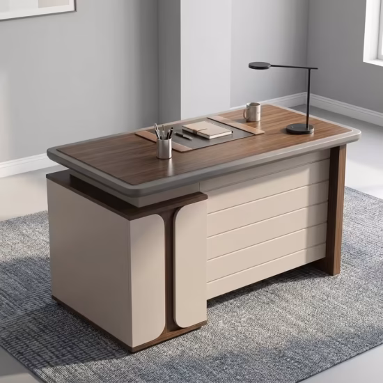 Premium 1.2M Modern Wooden Office Desk featuring a rich walnut woodgrain top panel, an integrated matte charcoal gray 3-drawer storage pedestal on the left with silver handles and gold trim, an open laptop, mouse pad, and notebooks on top, resting on a textured geometric cream area rug over a polished concrete floor.