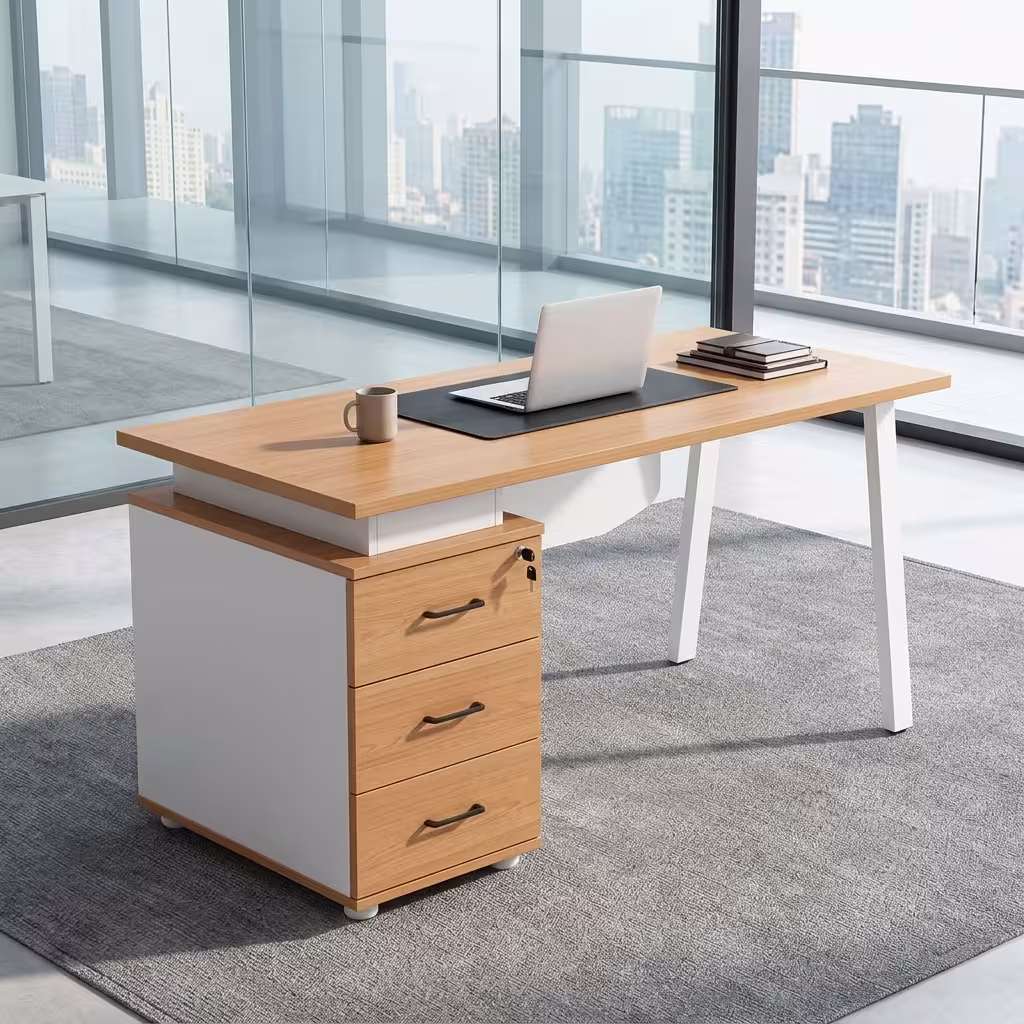 Premium 1.4M Executive Desk With 3-Drawer Storage in a dark walnut woodgrain finish, showcasing a flat rectangular tabletop supporting an open laptop, a pen holder set, and stacked books, with an integrated side storage pedestal showing a key lock and silver bar handles, standing on a polished concrete floor.