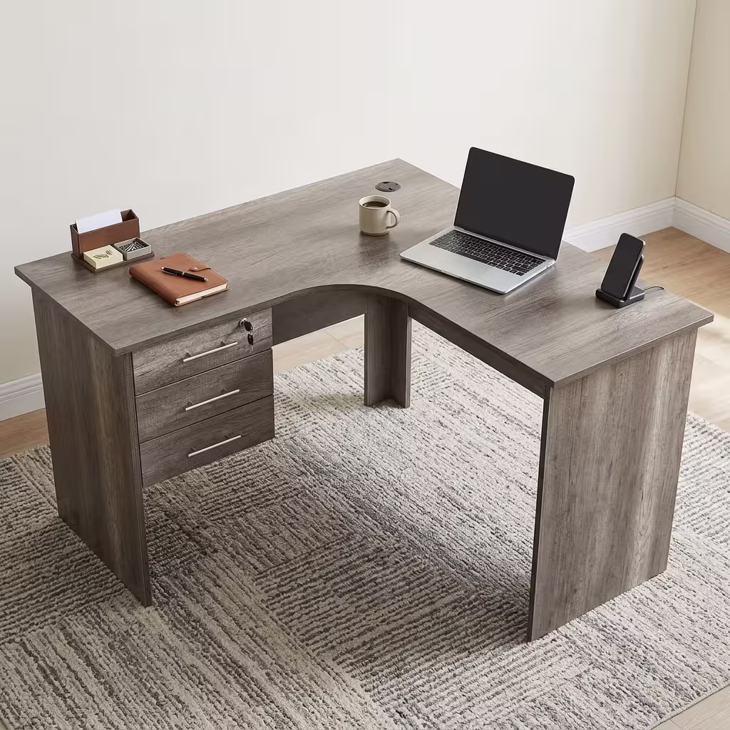 Premium 1.2M Curved Office Desk With Drawers in a warm oak woodgrain finish, showcasing a flat rectangular left-hand curved tabletop supporting a desktop computer monitor, keyboard, mouse, modern desk lamp, and a ceramic mug, with an integrated storage drawer pedestal showing a key lock, resting on a textured light tan area rug.