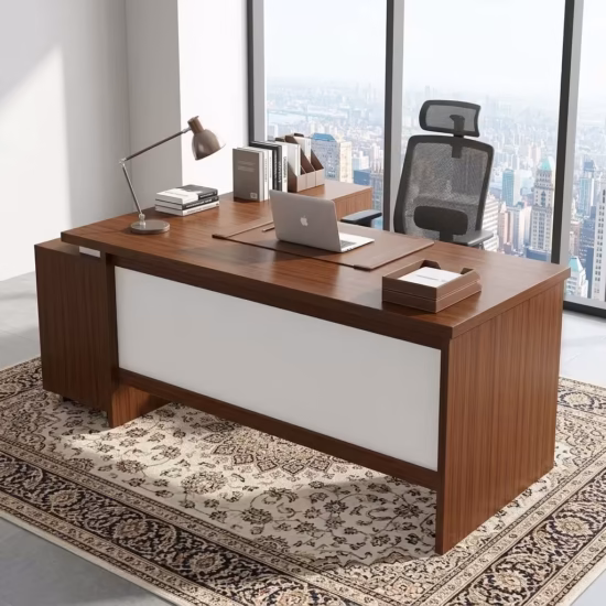 Premium 1.8M Custom Office Desk With Mobile Extension in a deep cherry-mahogany woodgrain finish, featuring an off-white front modesty panel, an integrated left-side storage console, an attached side return cabinet supporting an open laptop computer on a dark brown leather desk blotter mat, a classic silver articulating arm desk lamp, and stacked books, resting on an ornate patterned traditional area rug.