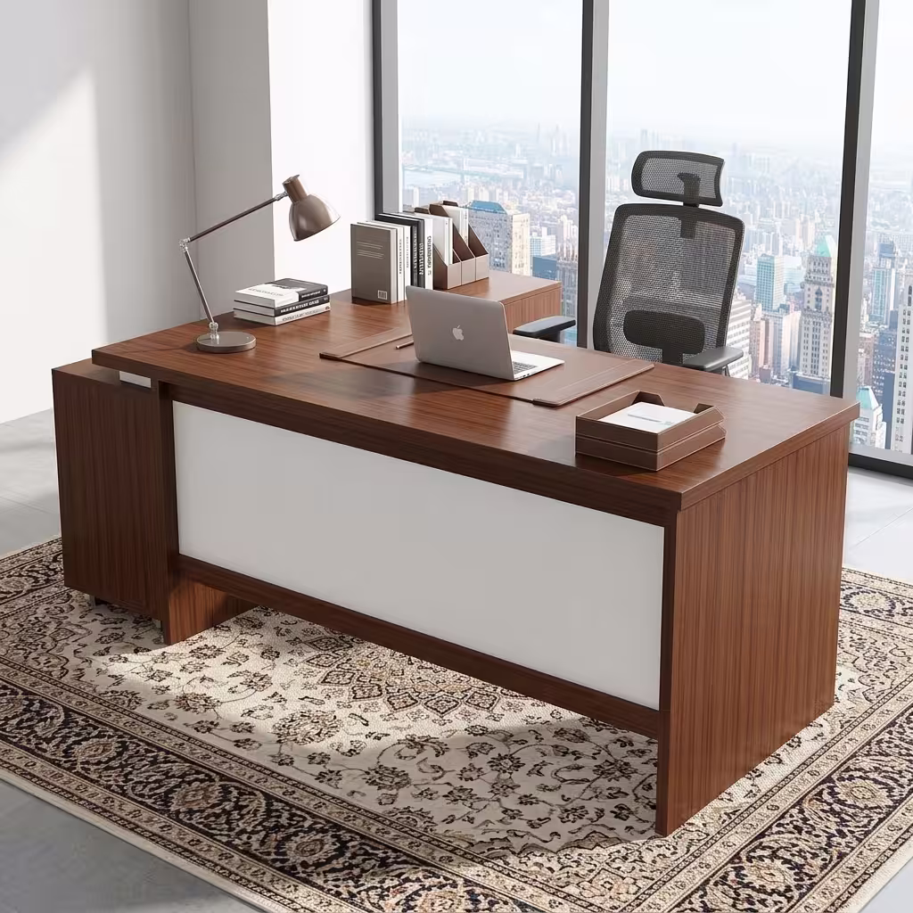 Premium 1.8M Custom Office Desk With Mobile Extension in a deep cherry-mahogany woodgrain finish, featuring an off-white front modesty panel, an integrated left-side storage console, an attached side return cabinet supporting an open laptop computer on a dark brown leather desk blotter mat, a classic silver articulating arm desk lamp, and stacked books, resting on an ornate patterned traditional area rug.