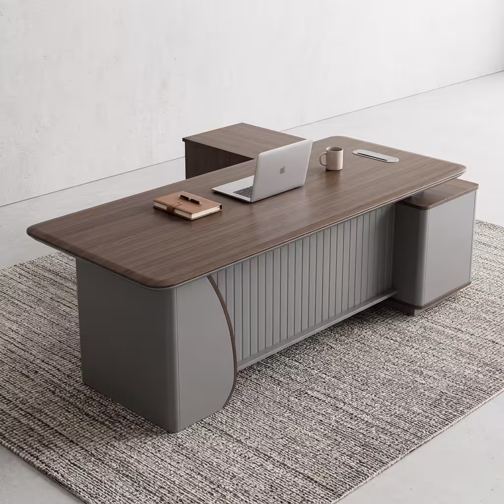 Premium 1.8M Executive Director's Office Desk in a dark charcoal-brown woodgrain finish, featuring a vertical matte grey fluted slatted front modesty panel, an integrated left-side return storage console, a right-side drawer block pedestal, a desktop supporting an open silver laptop, a leather notebook, and a ceramic mug, resting on a textured striped grey area rug.