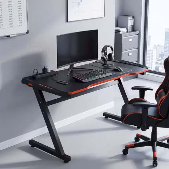 Premium Gaming Desk With Led Light in a sleek matte black carbon fiber texture, showcasing a stable Z-shaped black metal frame, an expansive desktop holding a widescreen curved monitor, mechanical gaming keyboard, mouse, and a beige mug, standing on a polished concrete floor.