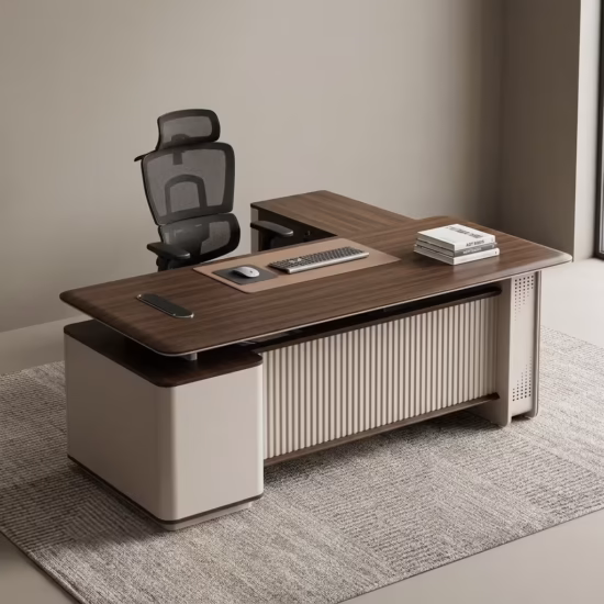 Premium 2.2M Executive CEO's Office Desk featuring a rich walnut woodgrain finish, an integrated tan leather desk blotter mat supporting a wireless mouse and keyboard, a front modesty panel with an off-white vertical fluted slatted design, and an attached side return storage console supporting stacked books, paired with a high-back black mesh office chair on a textured grey area rug.