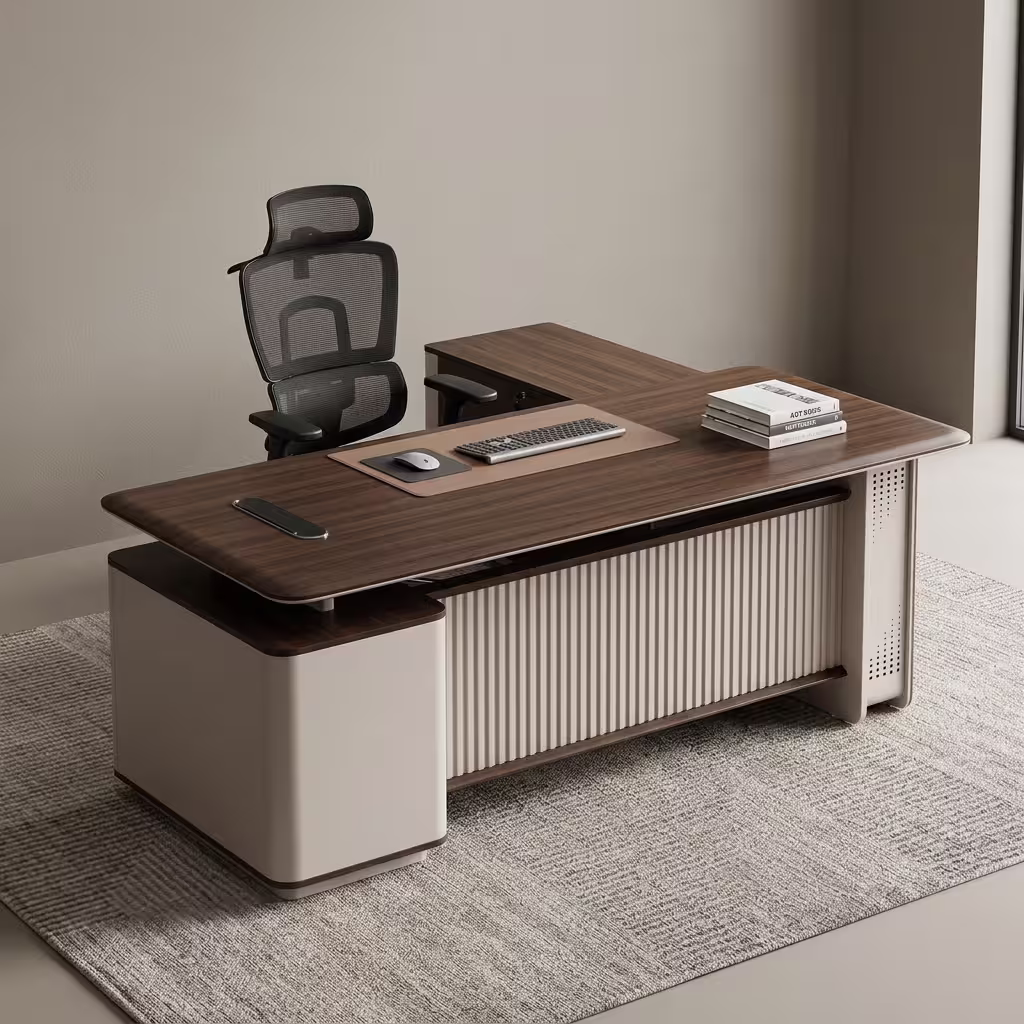 Premium 2.2M Executive CEO's Office Desk featuring a rich walnut woodgrain finish, an integrated tan leather desk blotter mat supporting a wireless mouse and keyboard, a front modesty panel with an off-white vertical fluted slatted design, and an attached side return storage console supporting stacked books, paired with a high-back black mesh office chair on a textured grey area rug.
