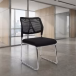 Premium Armless Guest Office Chair featuring a black mesh mid-backrest, a thick fabric upholstered seat cushion, an armless low-profile silhouette, and a continuous matte black steel cantilever sled frame, standing on a polished concrete floor.