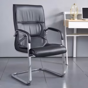 Premium PU Leather Office Visitor Chair featuring a black leatherette mid-backrest with horizontal pleat lines, integrated chrome armrests with matching black top pads, and a highly reflective continuous chrome steel cantilever sled frame, standing on large grey tile flooring next to a small wooden desk.
