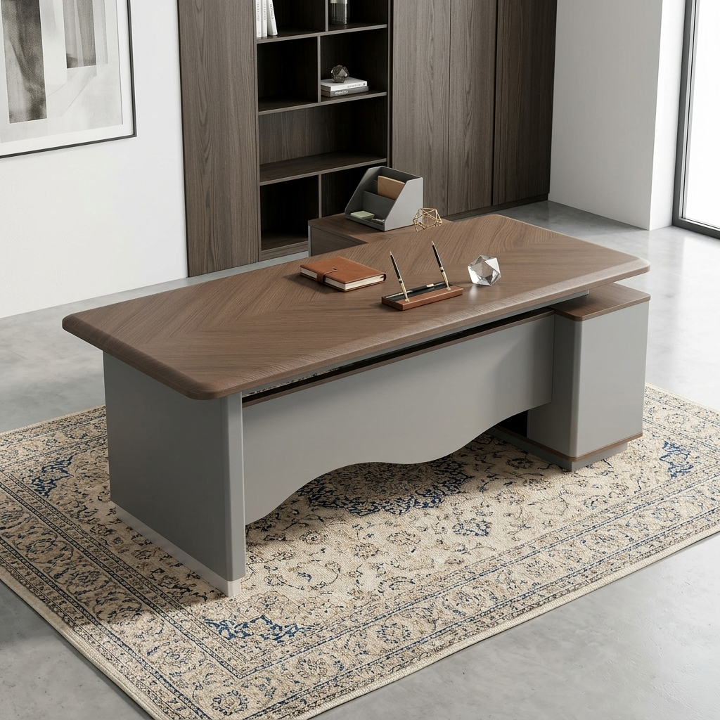 Premium 2.0M Executive L-Shaped Office Desk featuring a rich walnut woodgrain finish, an integrated tan leather desk blotter mat supporting an open laptop computer and a wireless mouse, a front modesty panel with a wave-curved matte grey design, and an attached side return storage console supporting a minimalist table lamp, resting on a textured cream and brown area rug.