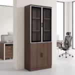 Premium 2-Door Half-Glass Office Cabinet in a walnut woodgrain finish, showcasing an upper section with two silver aluminum-framed tempered glass doors and internal wooden shelves, a lower section with twin woodgrain doors secured by a cylinder key lock, standing on a smooth white floor inside a modern corporate office.